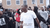 a man is dancing in front of a crowd of people .