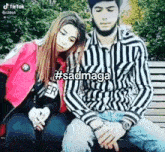 a man and a woman are sitting on a bench with #sadmaga written on the screen