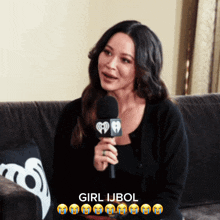 a woman sitting on a couch talking into a microphone with the name girl ijbol written on the bottom