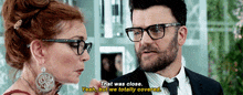 a man and a woman are looking at each other and the man says that was close but we totally covered