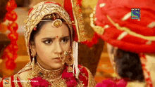 a woman in a traditional indian wedding dress is on a sony television show
