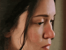 a close up of a woman 's face shows a red nose