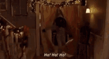 a man with a beard and mustache is wearing a furry hooded jacket and saying ho ! ho ! ho !