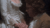 a man and woman holding hands in a dark room