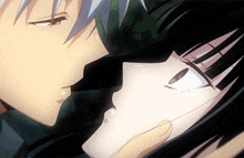 a close up of a man kissing a girl on the cheek