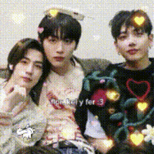 three young men are posing for a picture and one of them has a heart on his head