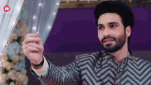 a man with a beard is taking a selfie