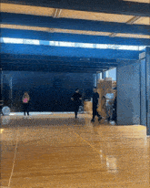 a group of people are standing in a large room with a black curtain behind them