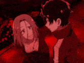 a man and a woman are standing next to each other in a dark room