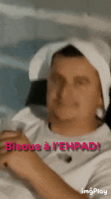 a man with a towel around his head says bisous a l' ehrpad !