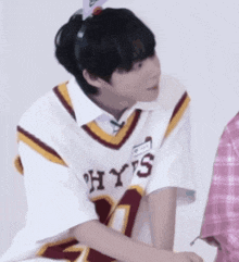 a person wearing a hys jersey sitting down