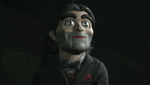 a puppet is giving a thumbs up with a heart in his mouth