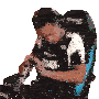 a man is sitting in a chair playing a video game .