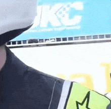 a close up of a person wearing a helmet and a yellow vest with a star on it .