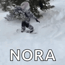 a picture of a child riding a snowboard with the name nora on it