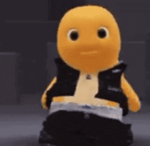 a yellow stuffed animal wearing a black vest and black pants is standing in a dark room .