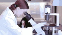 Scientist Looking Through Microscope GIF - Science Scientist Research GIFs