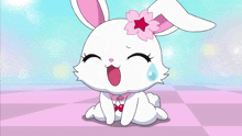 a cartoon rabbit with a flower on her head is sitting on a checkered floor