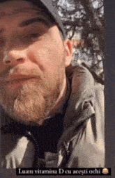 a man with a beard is wearing a hat and a jacket with the words luam vitamina d cu acesti ochi below him
