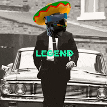 a man in a suit and sombrero is standing in front of a car that says legend on it