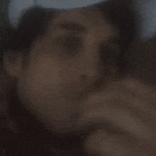 a blurry picture of a man 's face with a white hat on