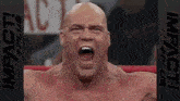 a bald man with his mouth open is in a boxing ring .