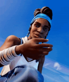a woman wearing a headband and bracelets is making a peace sign .
