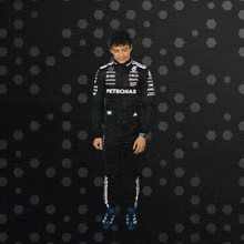 a soccer player wearing a black and white jersey with the word adidas on the front