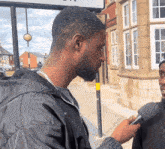 a man with a beard is being interviewed by another man with a microphone