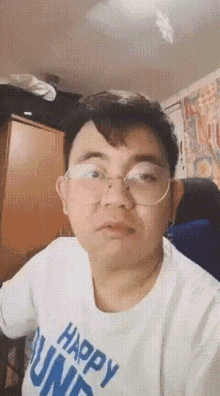 a man wearing glasses and a shirt that says happy bunnies