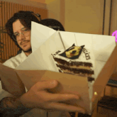a man is holding a piece of cake that says feliz on it
