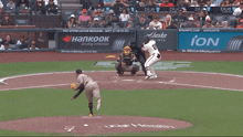 a baseball game is being played in front of a banner for ion