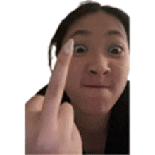 a woman is making a face and giving the middle finger .