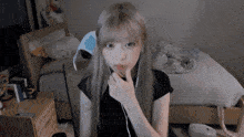 a girl with long blonde hair is wearing headphones and looking at the camera