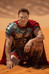 a man dressed as a roman soldier kneeling in the sand