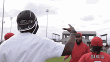 a man wearing a helmet and a jersey that says garcia