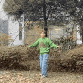 a young man wearing a green sweater that says texas on it
