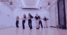 a group of girls are dancing in front of a wall that says secumber