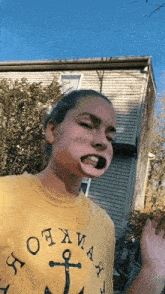 a girl wearing a yellow t-shirt that says ' ottawa ' on it