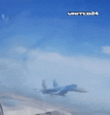 a bird is flying through a blue sky with the words unite 024 on the bottom