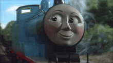 a close up of a thomas the tank engine with a smiling face