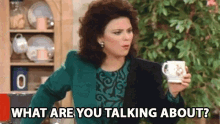 a woman is holding a cup of coffee and asking what she is talking about .