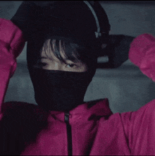 a person wearing a black mask with a triangle on it .