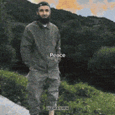 a man standing next to a dirt bike that says peace on the bottom