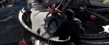 a man is fighting a spider-man in a parking lot with a truck in the background
