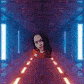 a pixelated image of a woman in a red shirt standing in a dark room
