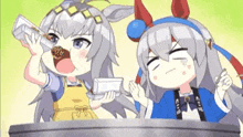 a couple of anime girls are sitting at a table drinking from a bottle .
