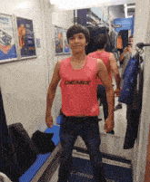 a man in a pink tank top that says demix on it
