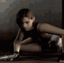 a woman is sitting on the floor with a gun in her hand