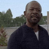 a man with a beard wearing a black shirt